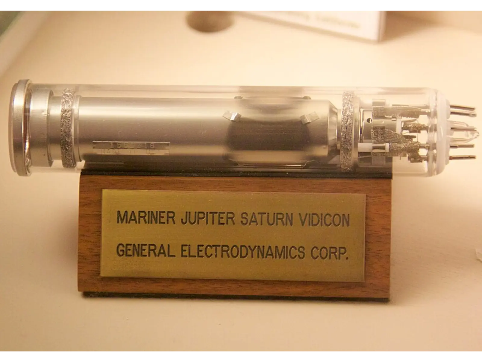 A vidicon tube made for the Voyager space cameras, on a wooden stand labelled Mariner Jupiter Saturn Vidicon, General Electrodynamics Corp.